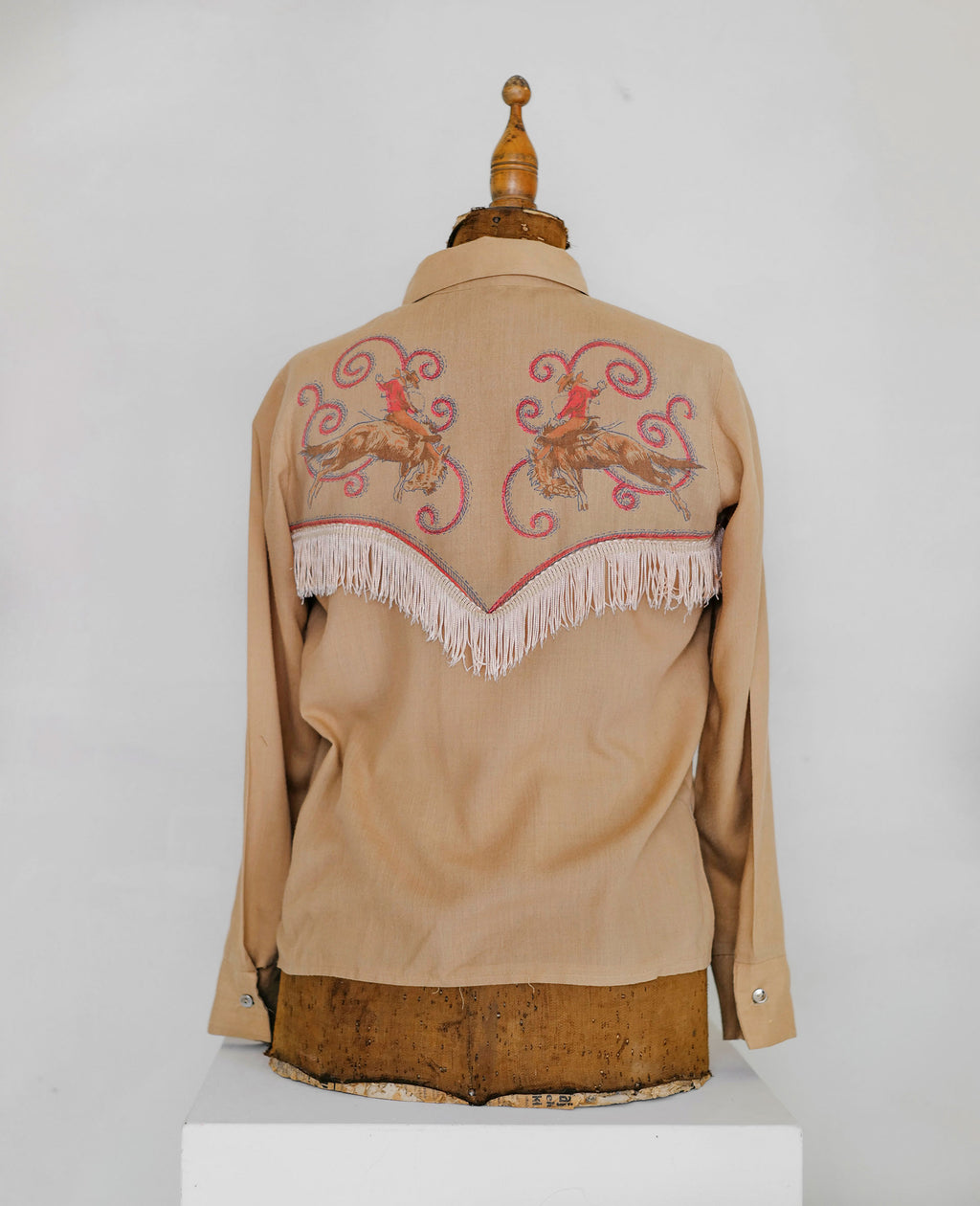 vintage western shirt with fringe and cowboy motif.